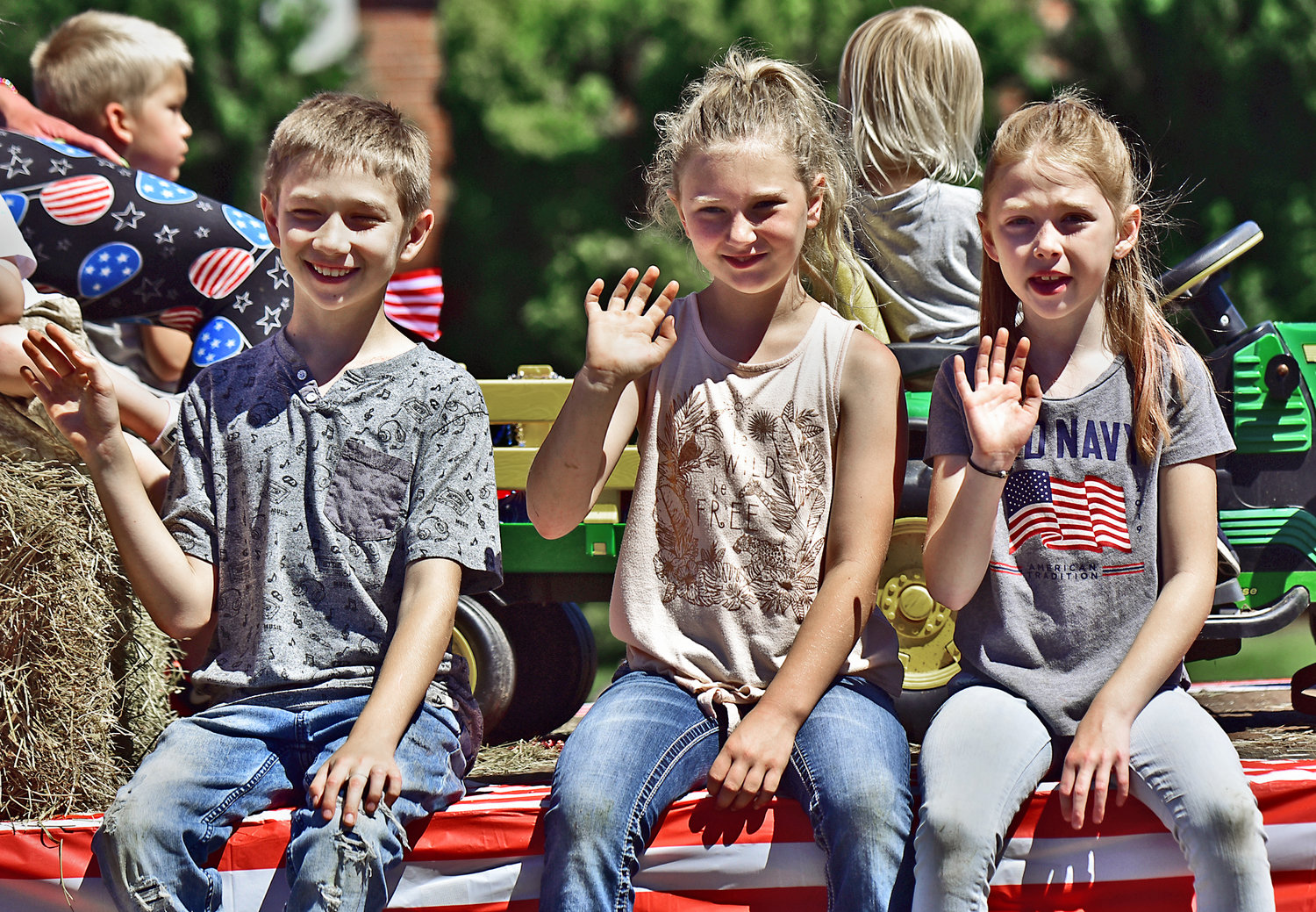 Kids representing the Washington State Grange wave from a float during the Swede Day parade on Satuday, June 19, in downtown Rochester.