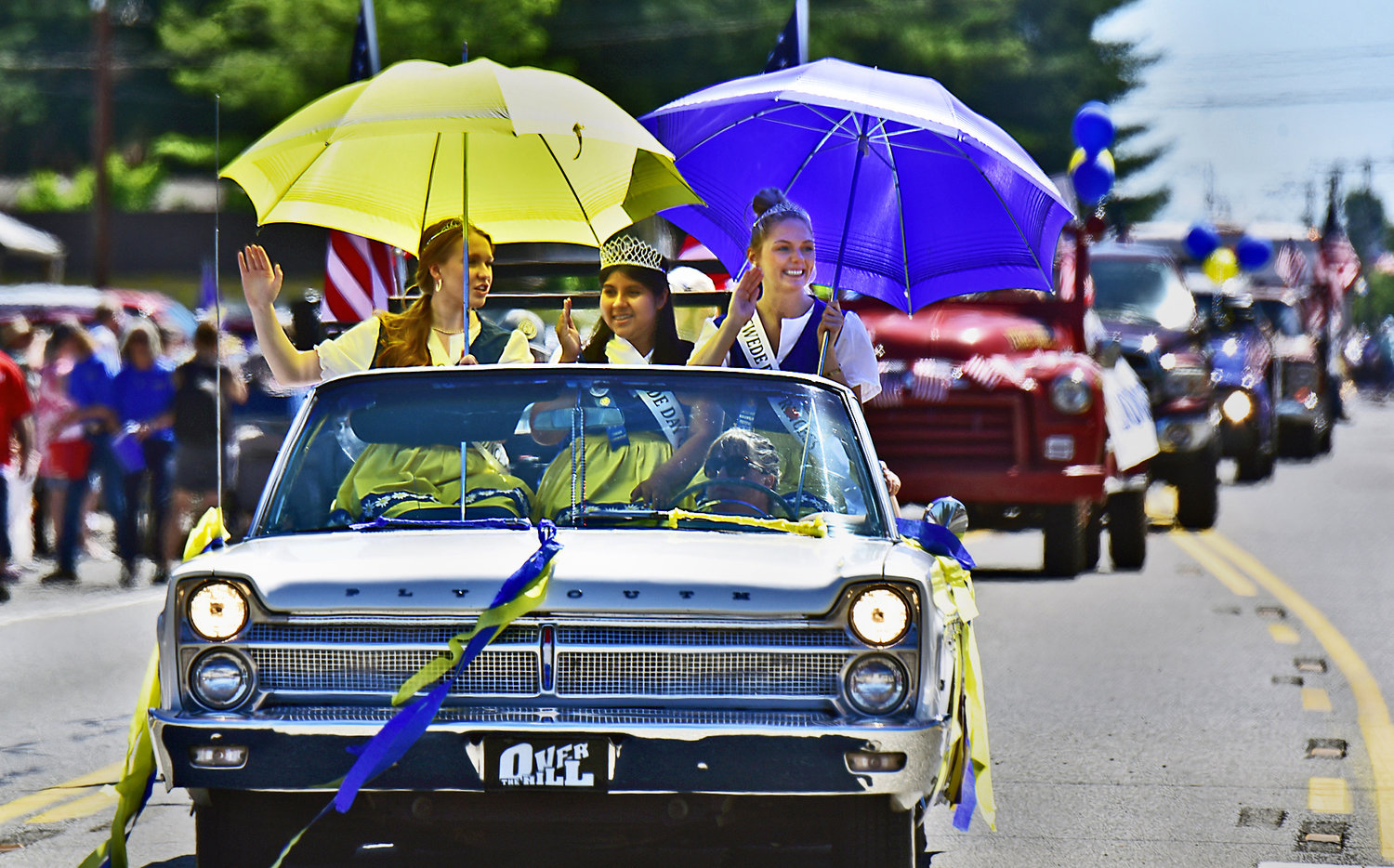 The Rochester Swede Day Royalty Court parades through downtown Rochester on Saturday, June 19, as a large crowd of enthusiastic people cheer them on. From left are: Amerika Jones, Brisa Ramirez, and Hannah Rodeheaver.