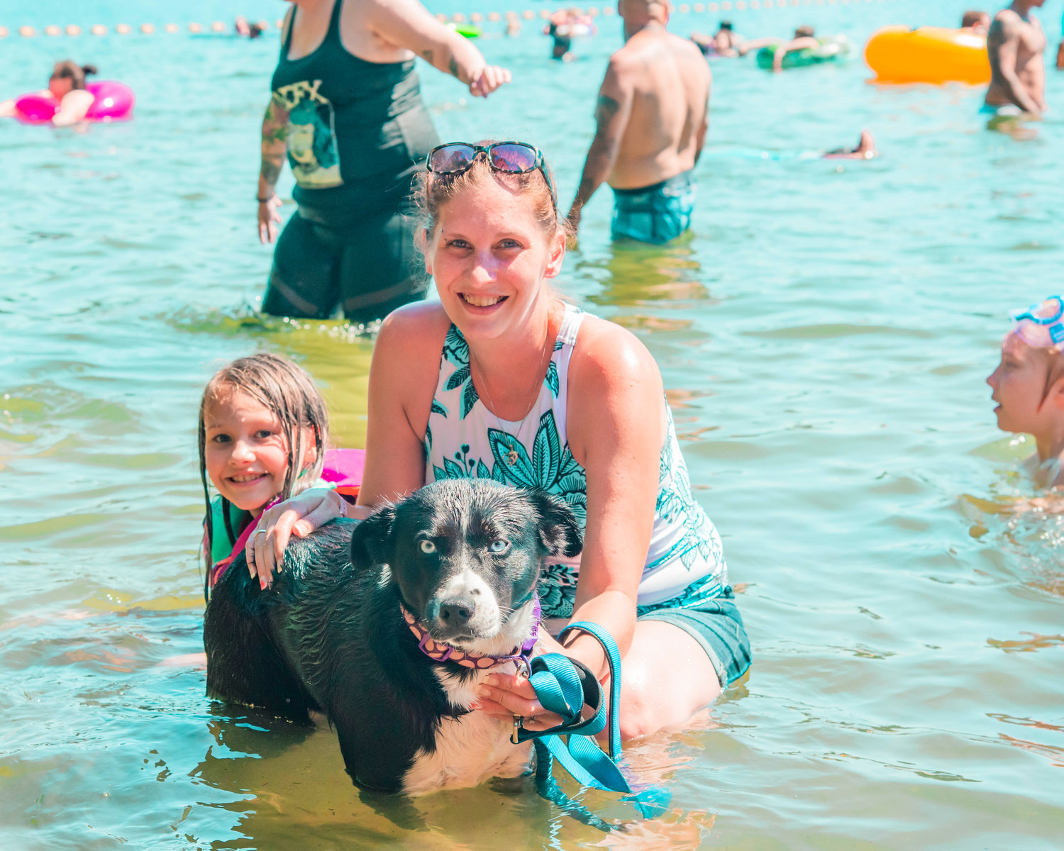 Meagan Houk smiles and poses for a photo with Lacy and their dog Callie at Deep Lake on Sunday.