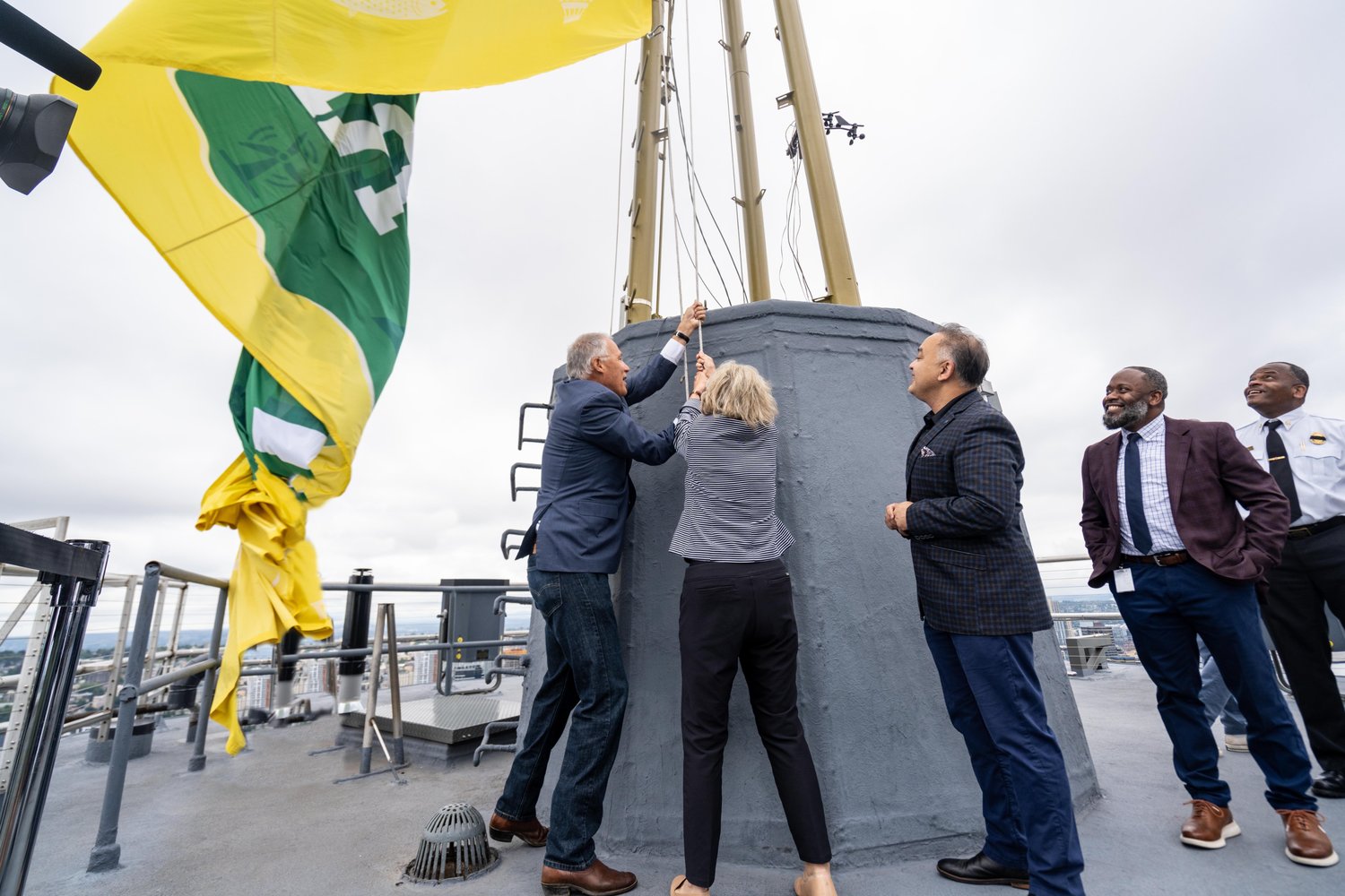 Gov. Jay Inslee celebrated Washington state's reopening on Thursday in typical Seattle fashion: on the roof of the Space Needle under a cloudy morning sky.