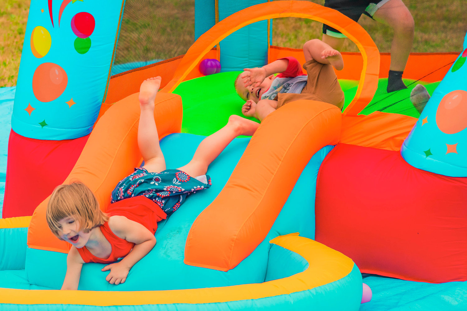 Kids play in a bounce house during celebrations for the Mossyrock Freedom Festival on Saturday in Klickitat Prairie Park.
