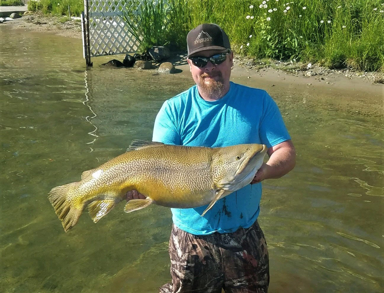 Caylun Peterson with his state record 24.49-pound tiger trout in Loon Lake on June 26, 2021.