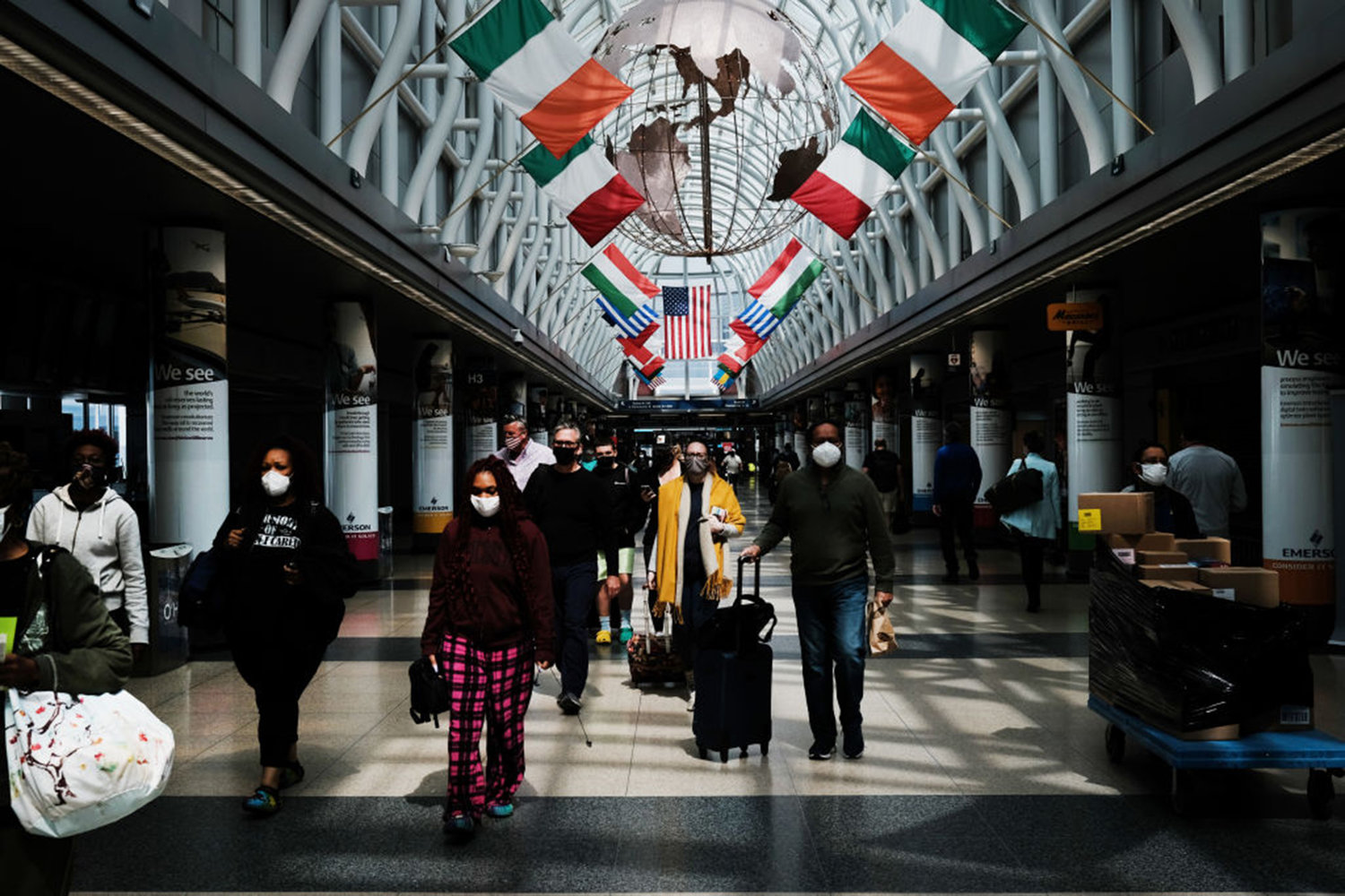 People walk through Chicago O’Hare airport on April 26, 2021 in Chicago, Illinois.