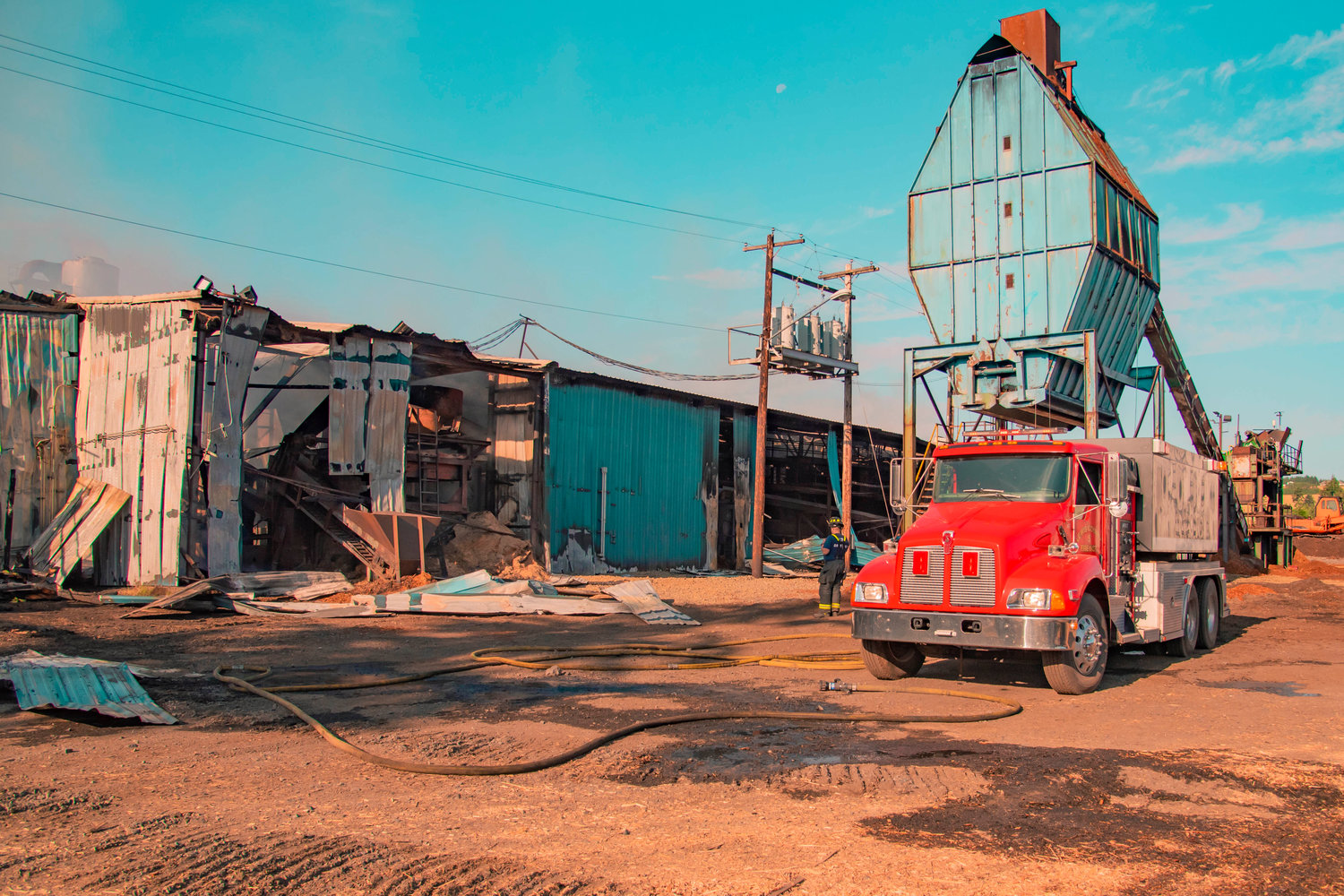 A Lewis County Fire District 5 engine responds to a fire at Winlock Fibre early Wednesday morning.