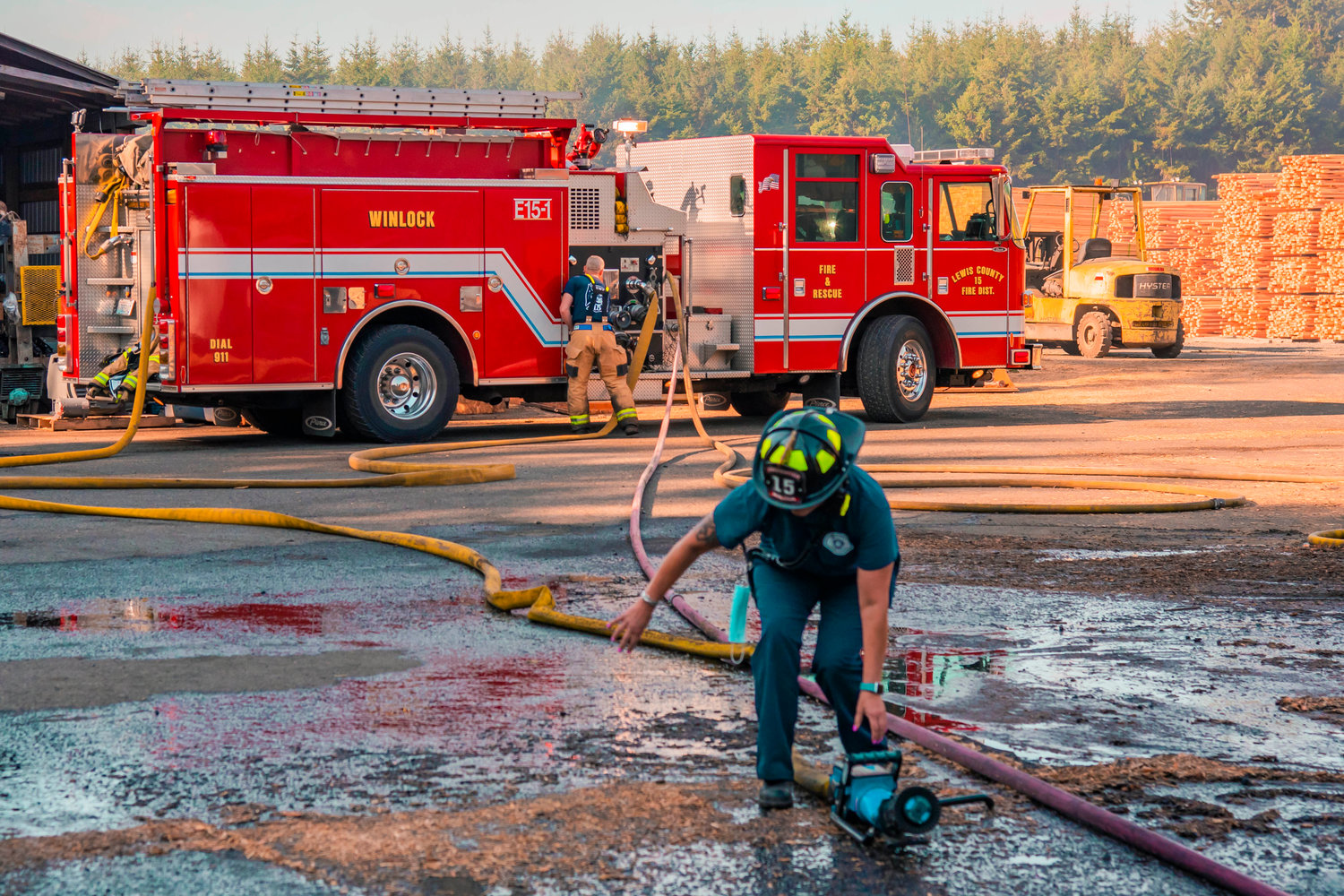 Lewis County Fire District 15 firefighters respond to the scene of a fire at Winlock Fibre early Wednesday morning.