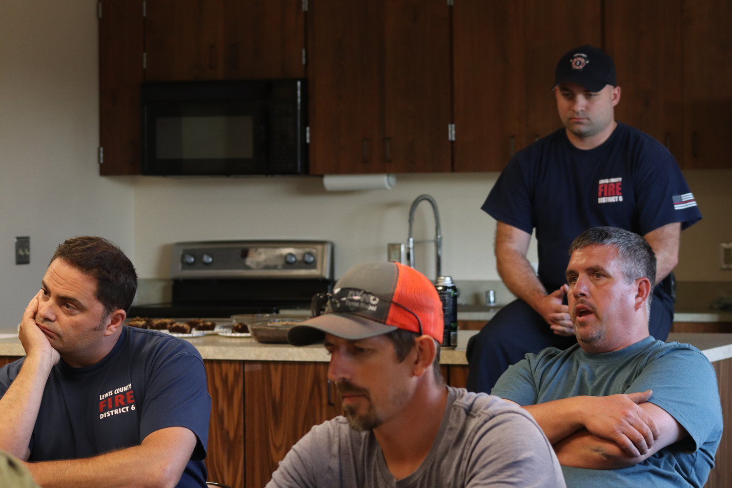 Firefighters sit among Adna community members at a Lewis County Fire District 6 board of commissioners meeting on July 27.