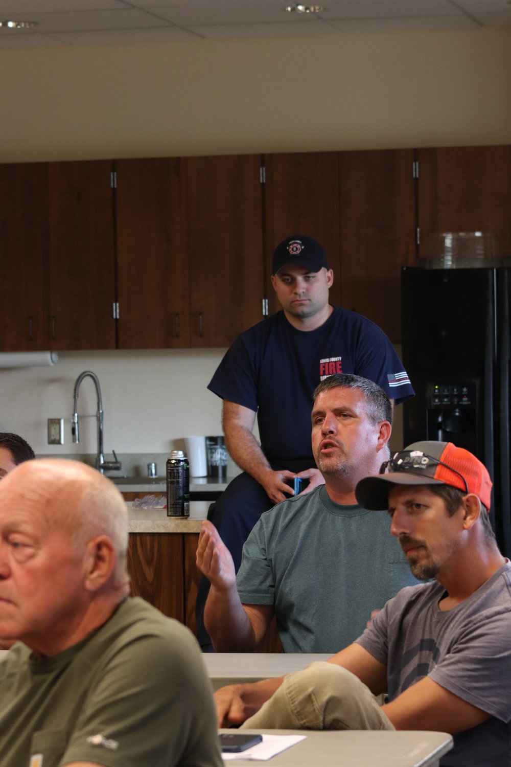 Firefighters sit among Adna community members at a Lewis County Fire District 6 board of commissioners meeting on July 27.
