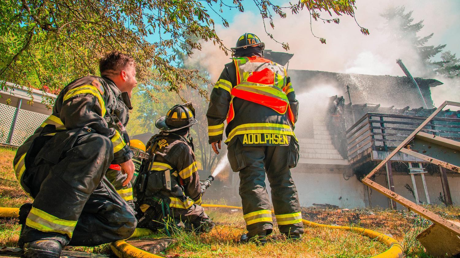 Riverside Fire Authority firefighters work to put out flames at a residential structure on East Third Street in Centralia on Thursday.