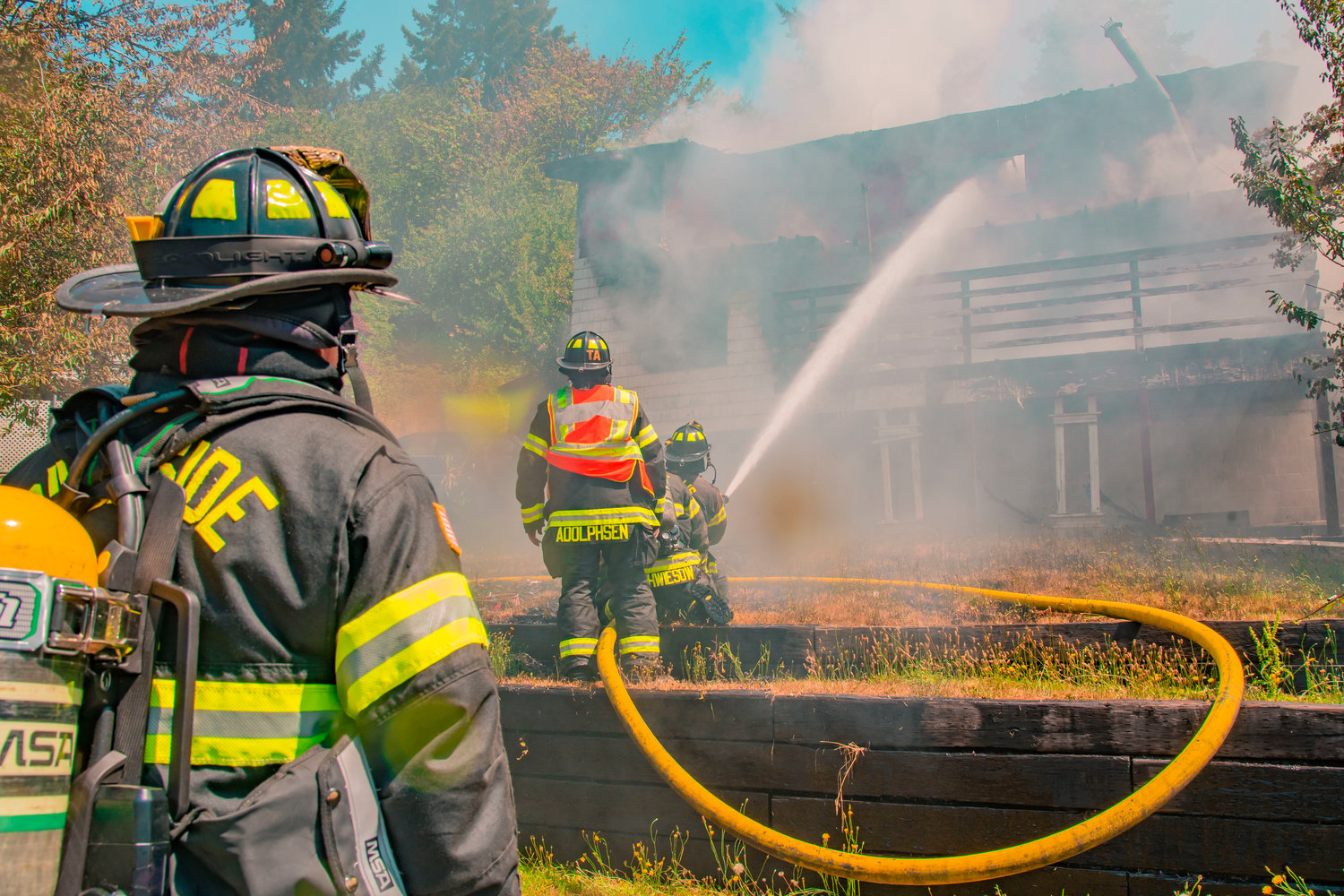 Riverside Fire Authority firefighters use a hose to put out flames at a residential structure on East Third Street in Centralia on Thursday.