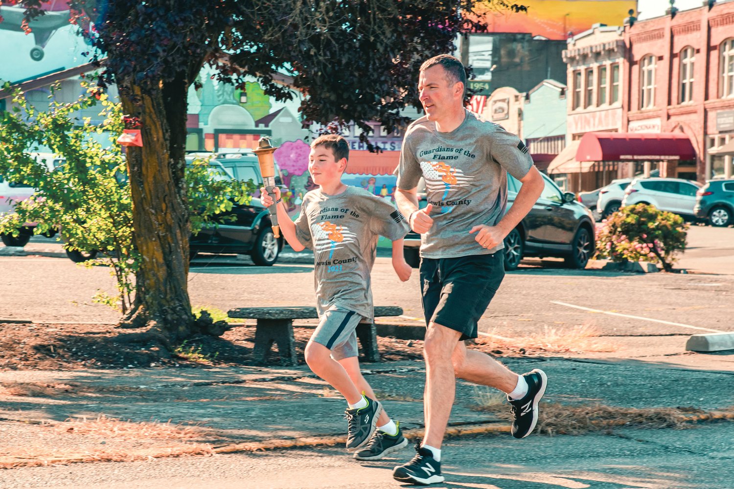 A torch is carried through downtown Chehalis during the Lewis County Law Enforcement Torch Run for the Special Olympics Saturday morning. Each runner from local law enforcement agencies participated on behalf of an athlete. Supporters donated money to sponsor a favorite first responder or Special Olympics athlete. The funds raised each year are an important part of keeping the opportunities available for local athletes. Learn more at lewiscountyletr.com.