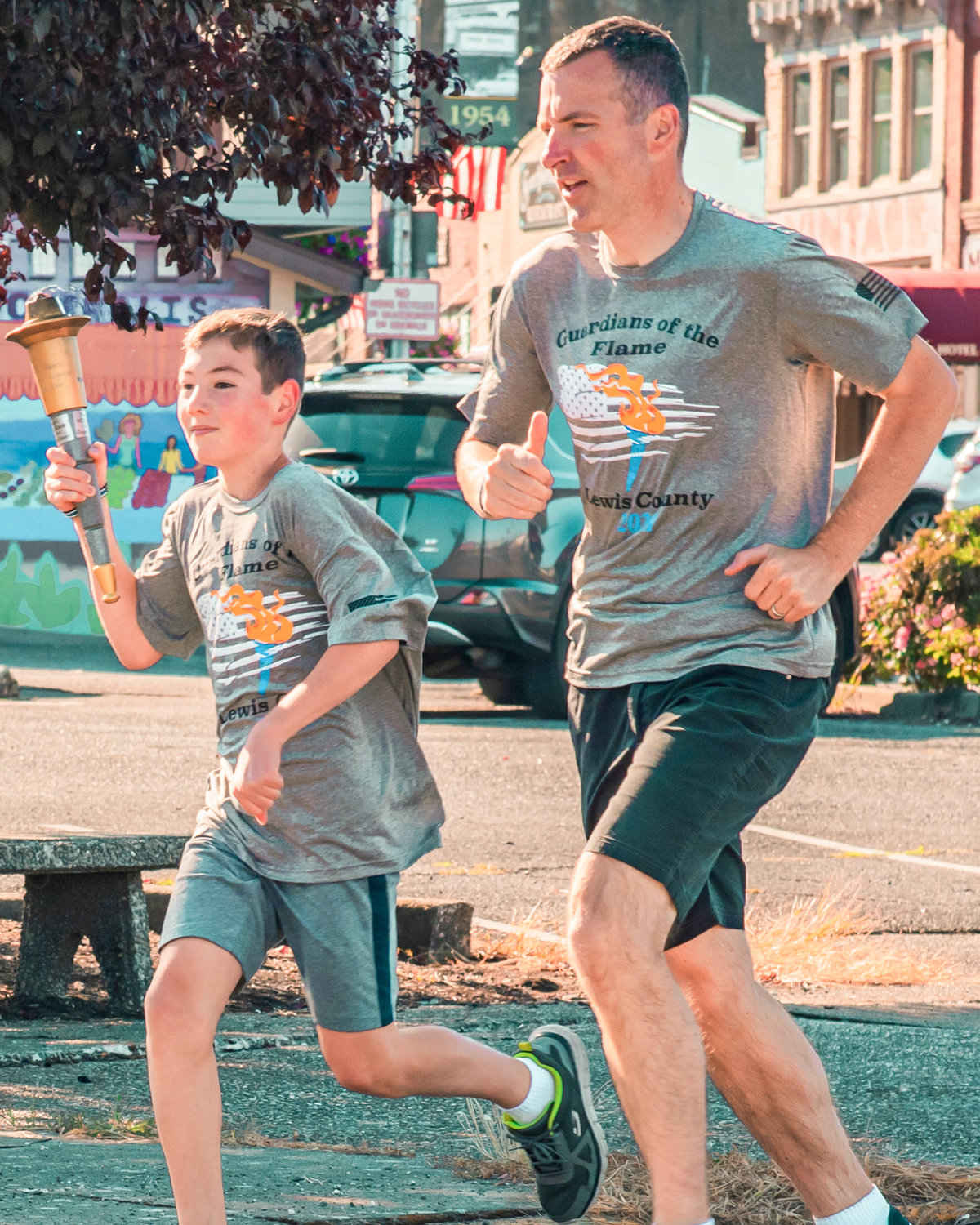 A torch is carried through downtown Chehalis during the Lewis County Law Enforcement Torch Run for the Special Olympics Saturday morning.