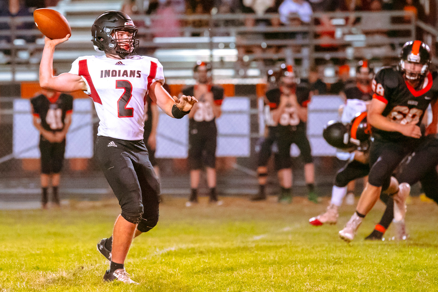Toledo’s Wyatt Nef (2) looks to pass during a game against the Mountaineers Friday night at Rainier High School.