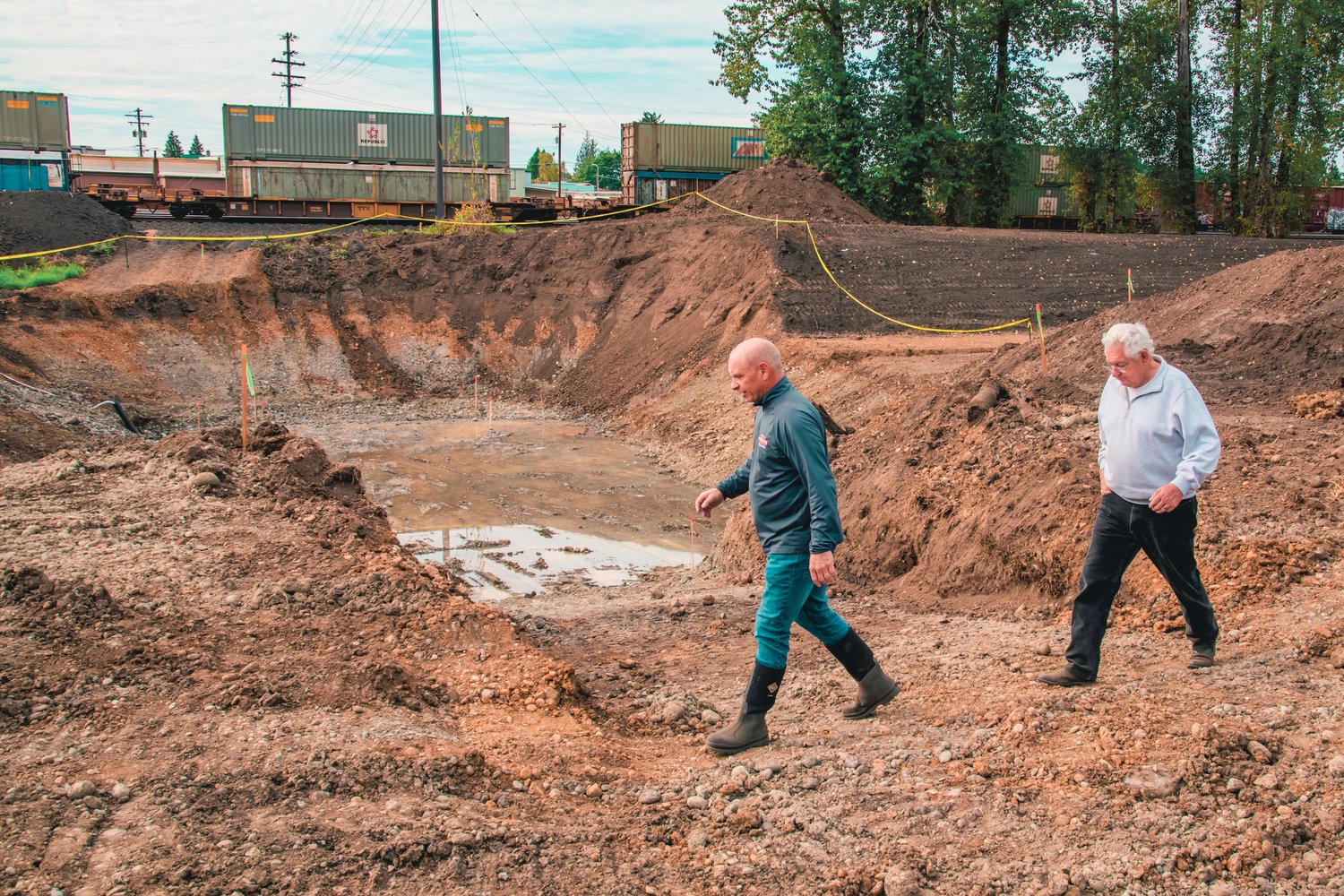 Kim Ashmore, with the City of Centralia, and former Centralia Mayor Lee Coumbs walk by a pit that will be used to feed overflow water back into China Creek, during a tour on Friday of the China Creek Project.
