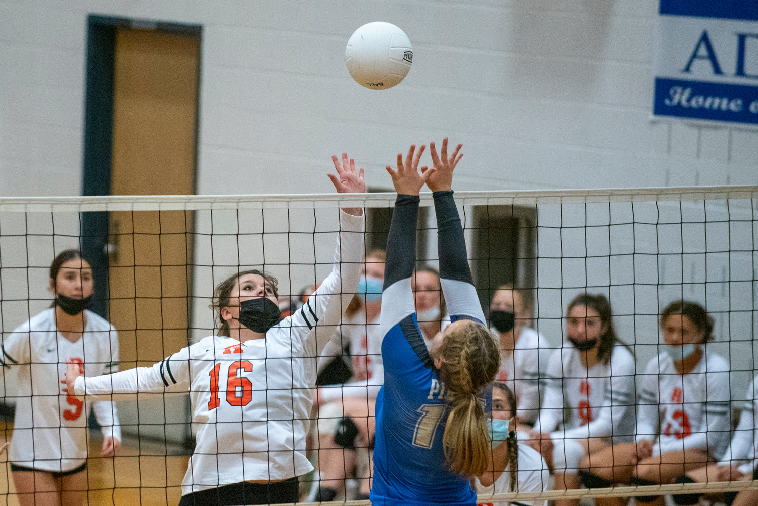 Rainier's Autumn Kenney (16) fights at the net against Adna on Saturday.