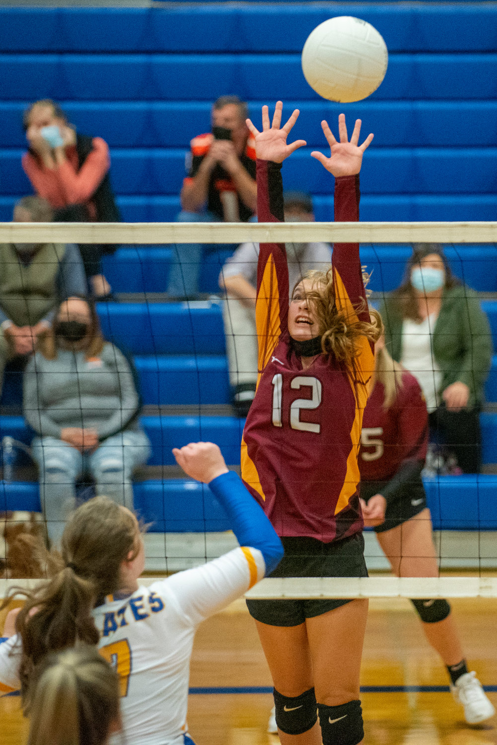 A Winlock player goes for a block against Adna on Saturday.
