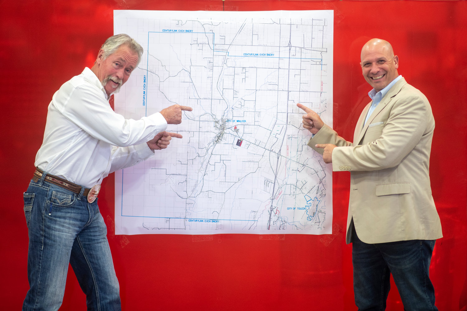ToledoTel' Vice President and Chief Operating Officer Dale Merten, left, and state Rep. Peter Abbarno, R-Centralia, pose in front of a map of Winlock that shows a proposed high-speed Internet expansion.