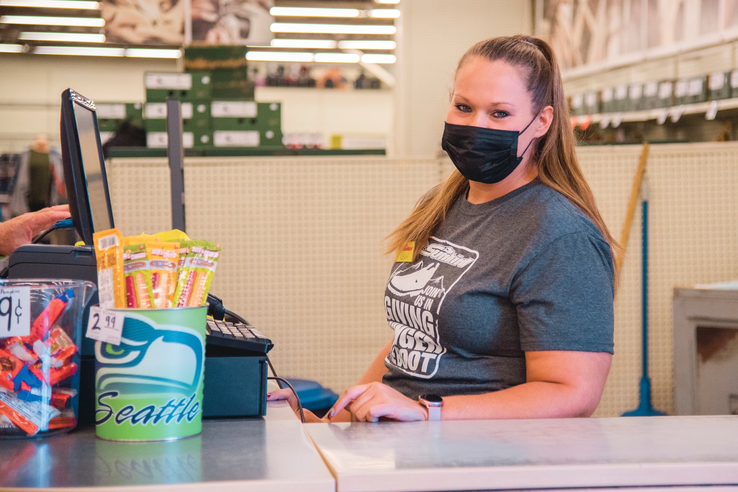 Leah Williams works the customer service table at the Sunbird Shopping Center in Chehalis Thursday morning.