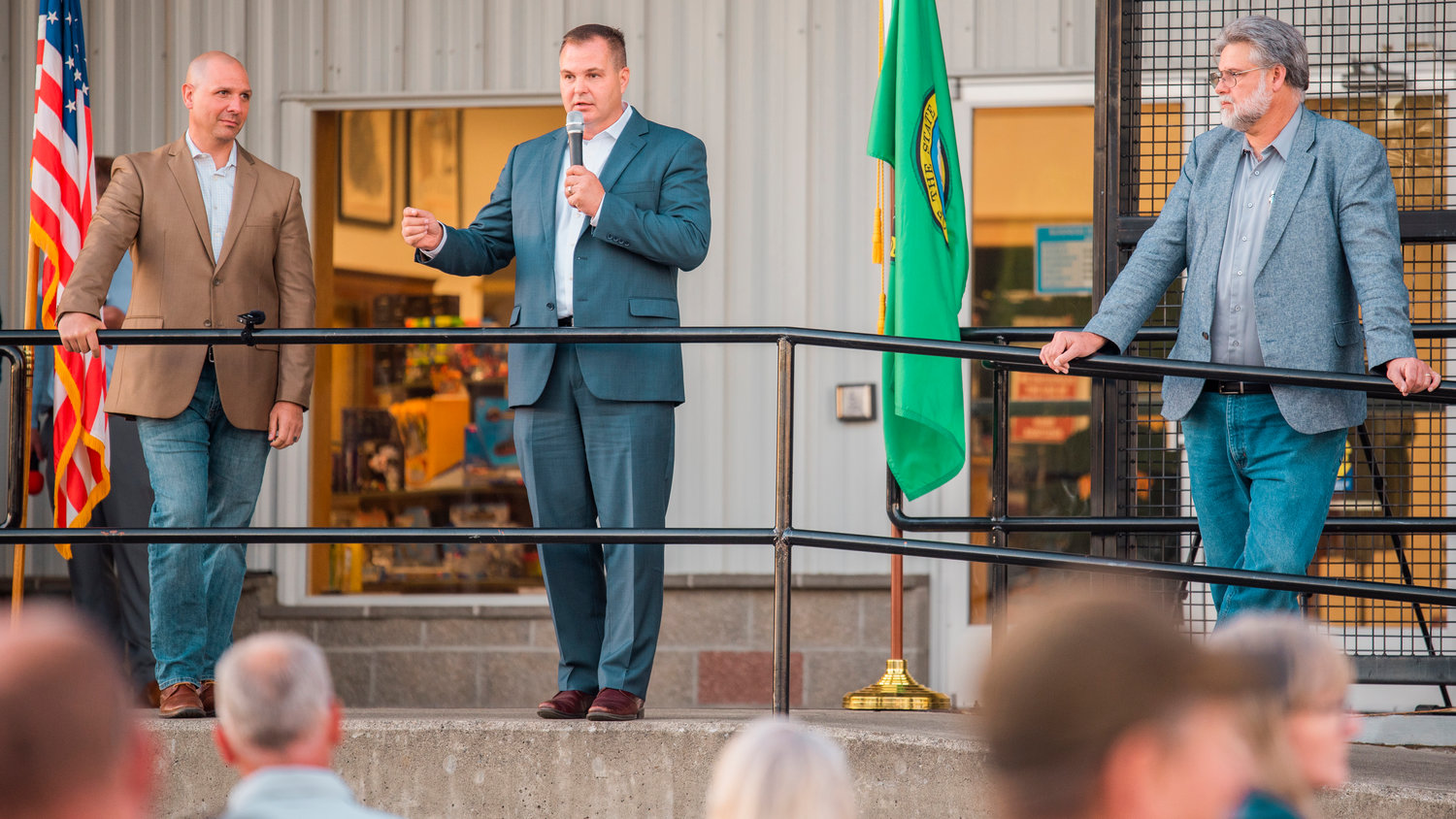 Washington state Sen. John Braun uses a microphone to speak to crowds during a town hall event at the Veterans Memorial Museum alongside sate Reps. Peter Abbarno and Ed Orcutt Monday evening in Chehalis.