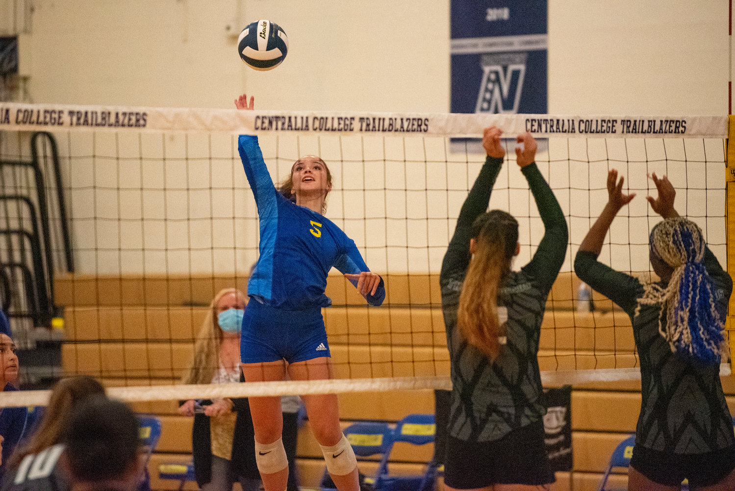 Centralia College's Kate Demery (5) leaps for a spike against Highline's block on Wednesday.
