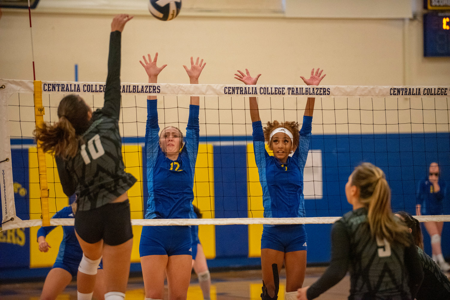 Centralia College's Samantha Witt (12) and Solana Stanley (1) attempt to block a Highline spike on Wednesday.