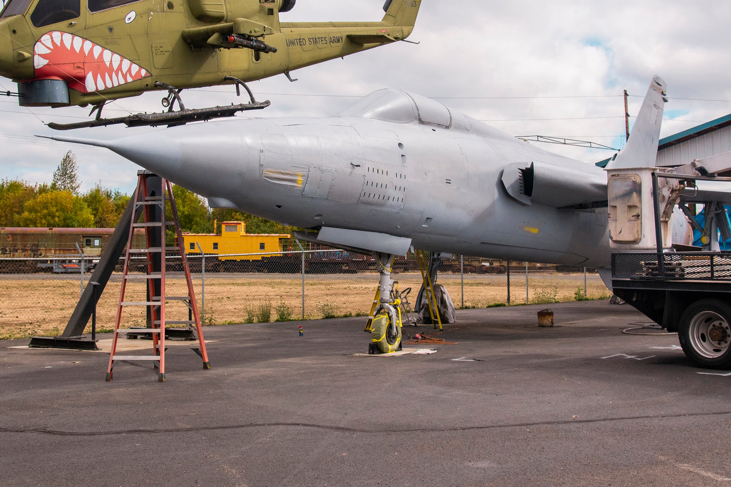 Imperfections and dents are removed before the repainting of a F-105 Thunderchief named Desert Fox displayed outside the Veterans Memorial Museum in Chehalis on Thursday.