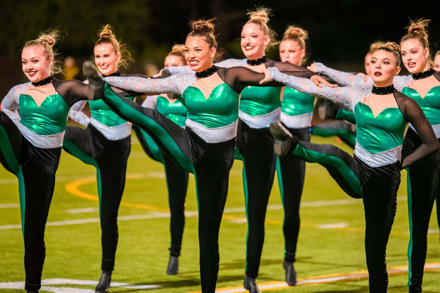 Members of the Tumwater Dance Team perform on the field at halftime under Friday night lights.