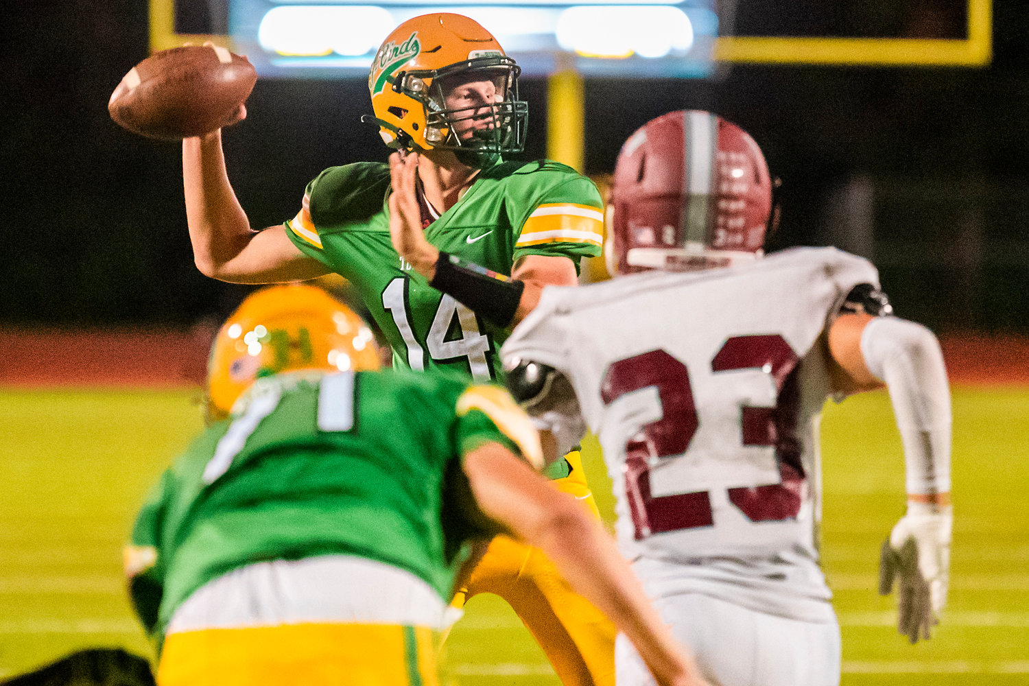 Tumwater’s quarterback Alex Overbay looks to pass as defenders close in Friday night during a game against W.F. West.