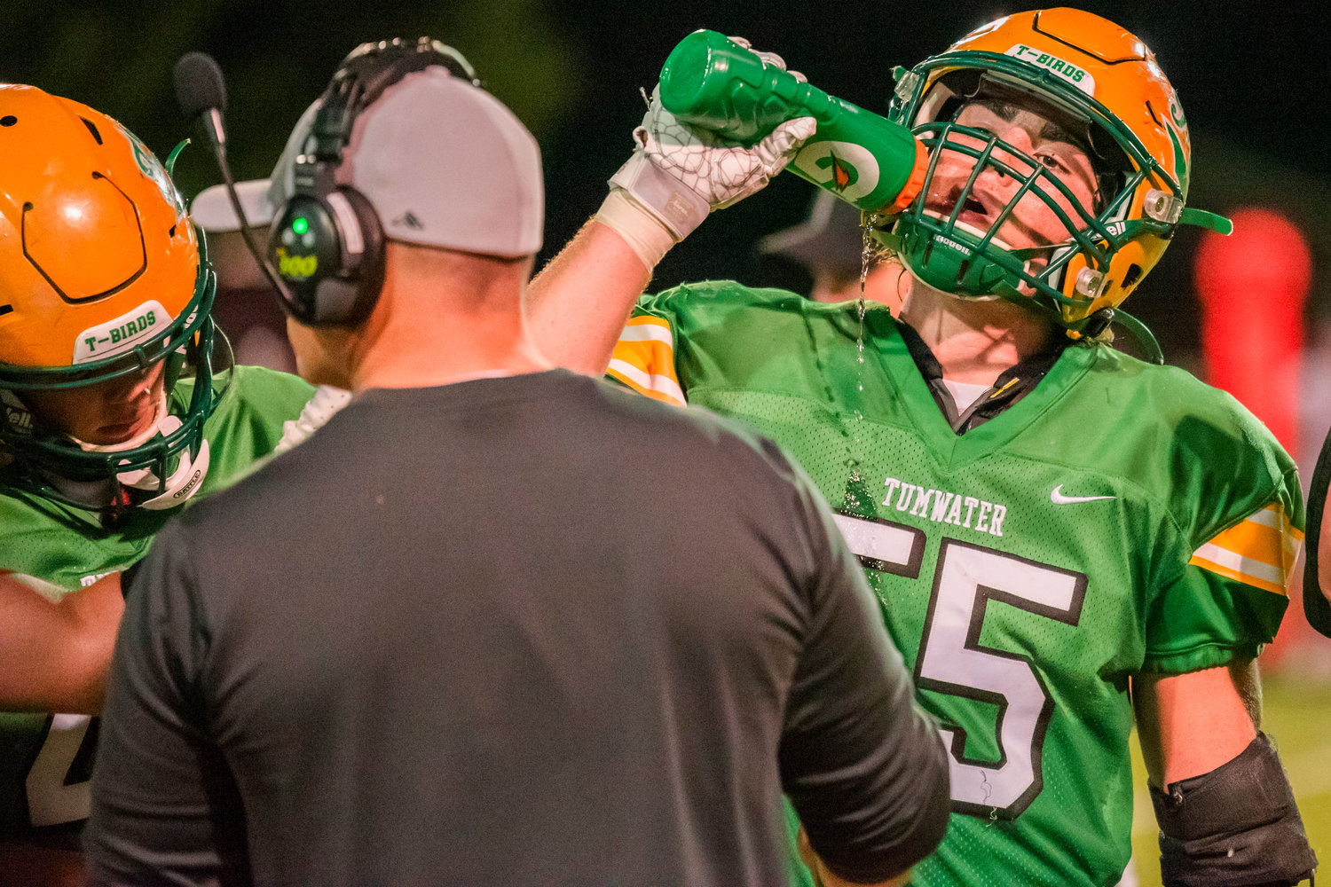 Tumwater’s Caleb Sadlemeyer (55) rehydrates during a game Friday night.
