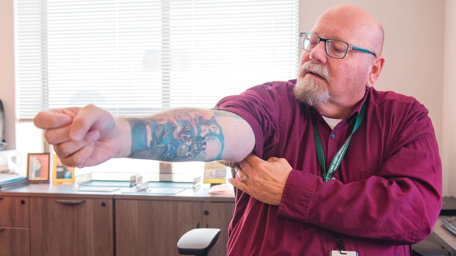 Ross McDowell shows off his Grateful Dead sleeve while sitting in his office Friday at the Lewis County Historic Courthouse in Chehalis.