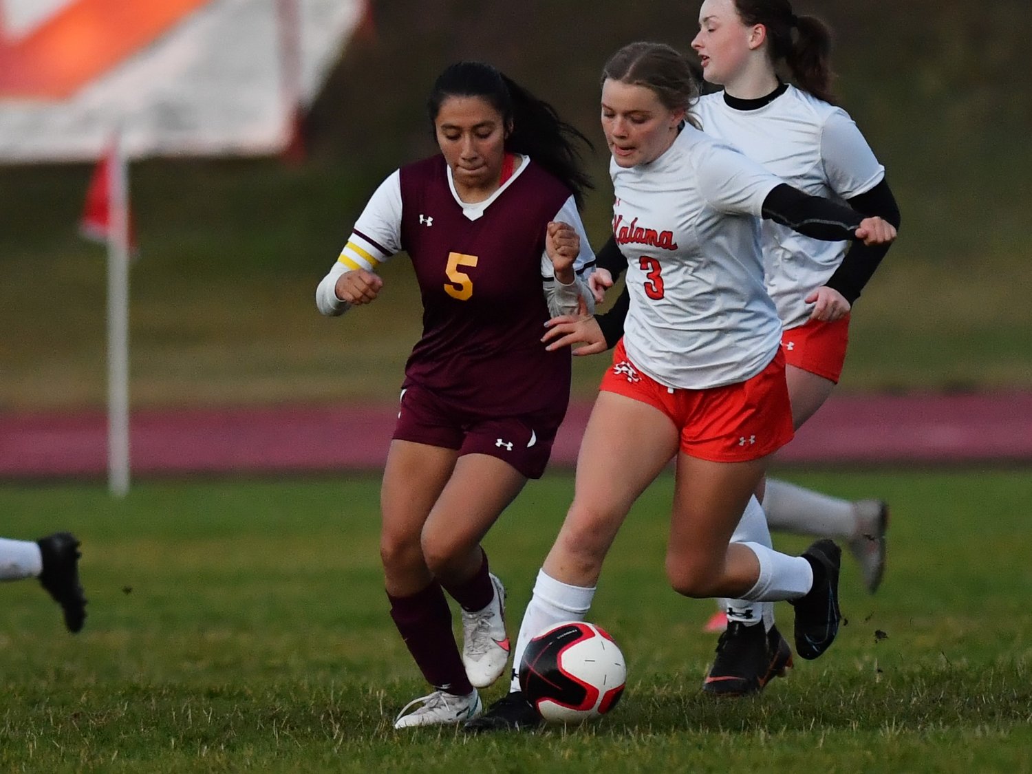 Winlock’s Angela Gil-Munoz fights for possession against Kalama’s Josie Brandenburg in the second half of the Chinooks’ 8-0 win over the Cardinals on Sept. 27.