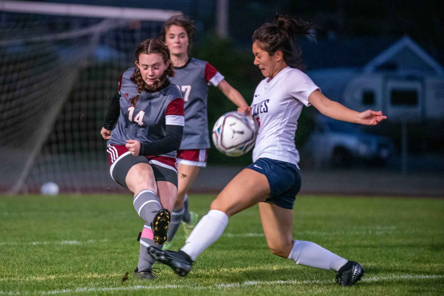 W.F. West's Madeline Shields (14) clears a ball past a Black Hills player on Tuesday at home.