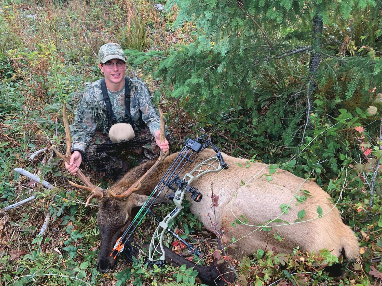 Tumwater High School student Luke Brewer with the elk he harvested near Pe Ell on opening day of archery season Sept. 11, 2021.