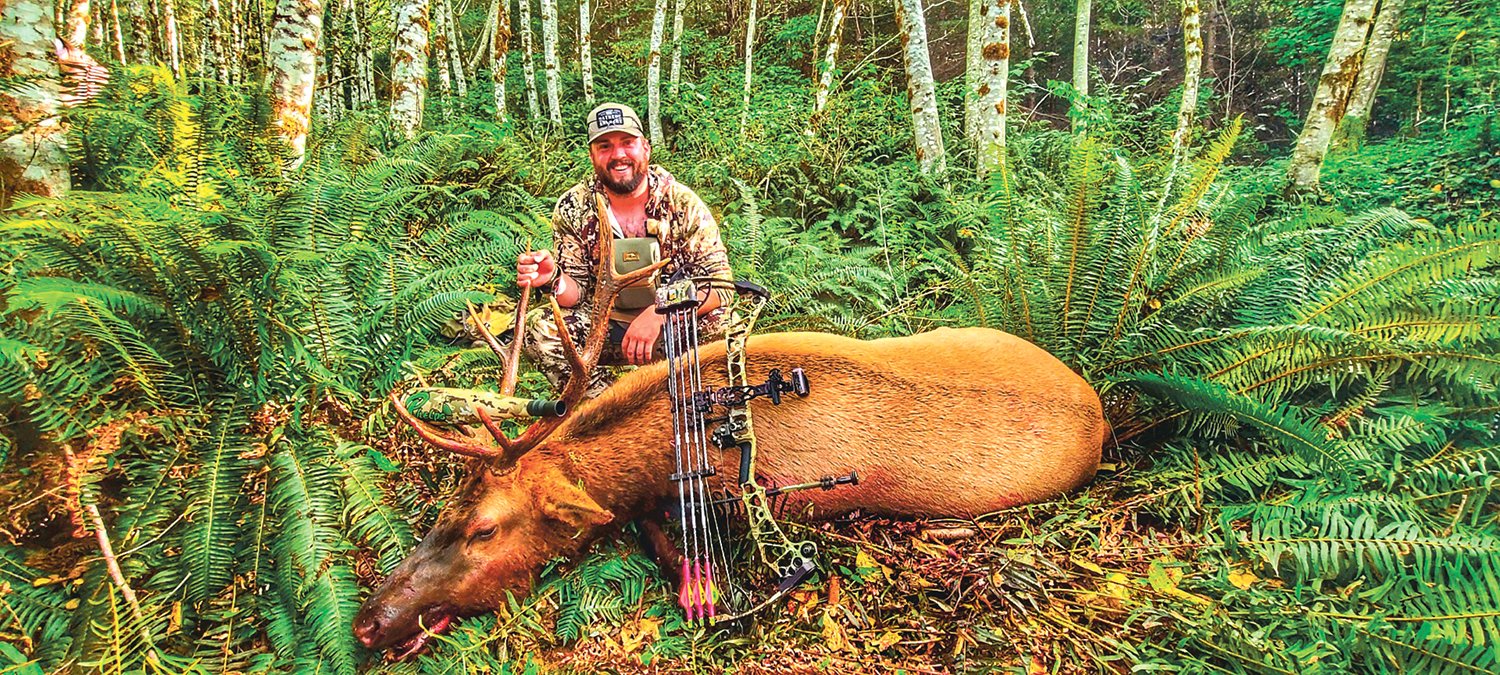 Centralia native Josh Westerly posing with the 4x5 elk he harvested south of Toledo, Washington on opening day of archery season on Sept. 11, 2021.