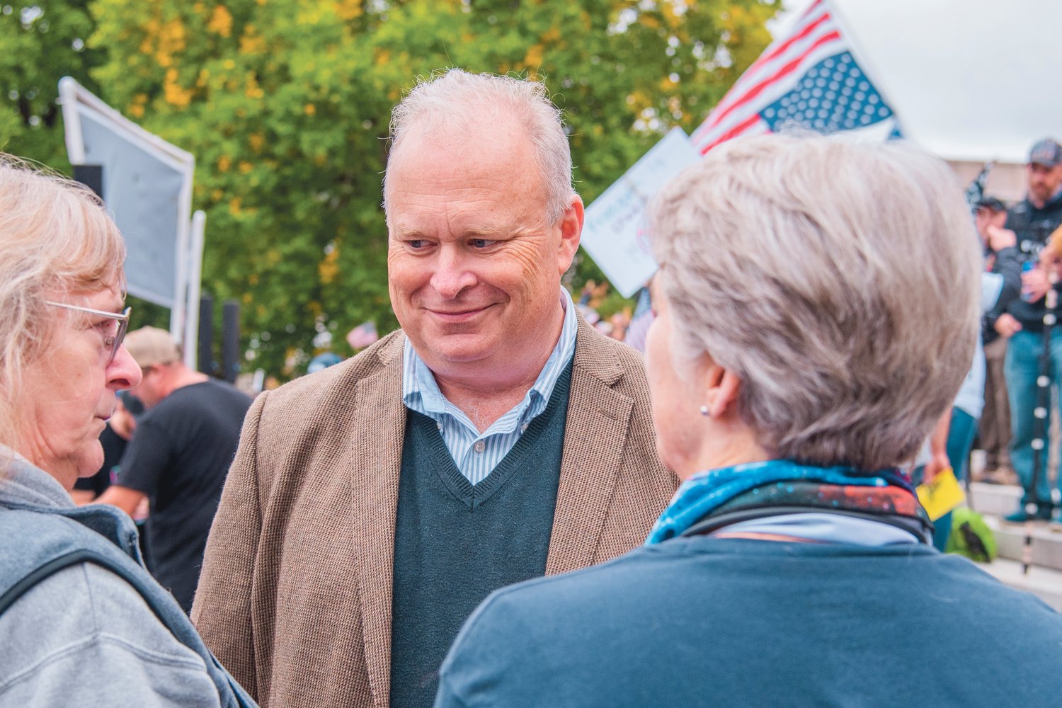 Representative Jim Walsh smiles while mingling with attendees of a “Medical Freedom Rally” outside the Washington State Capitol Building in Olympia in this file photo.