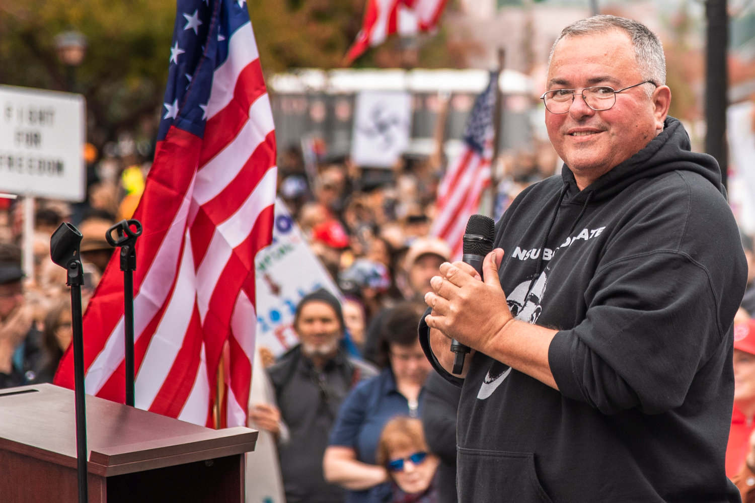 Loren Culp smiles while addressing crowds during a “Medical Freedom Rally” in Olympia last year.