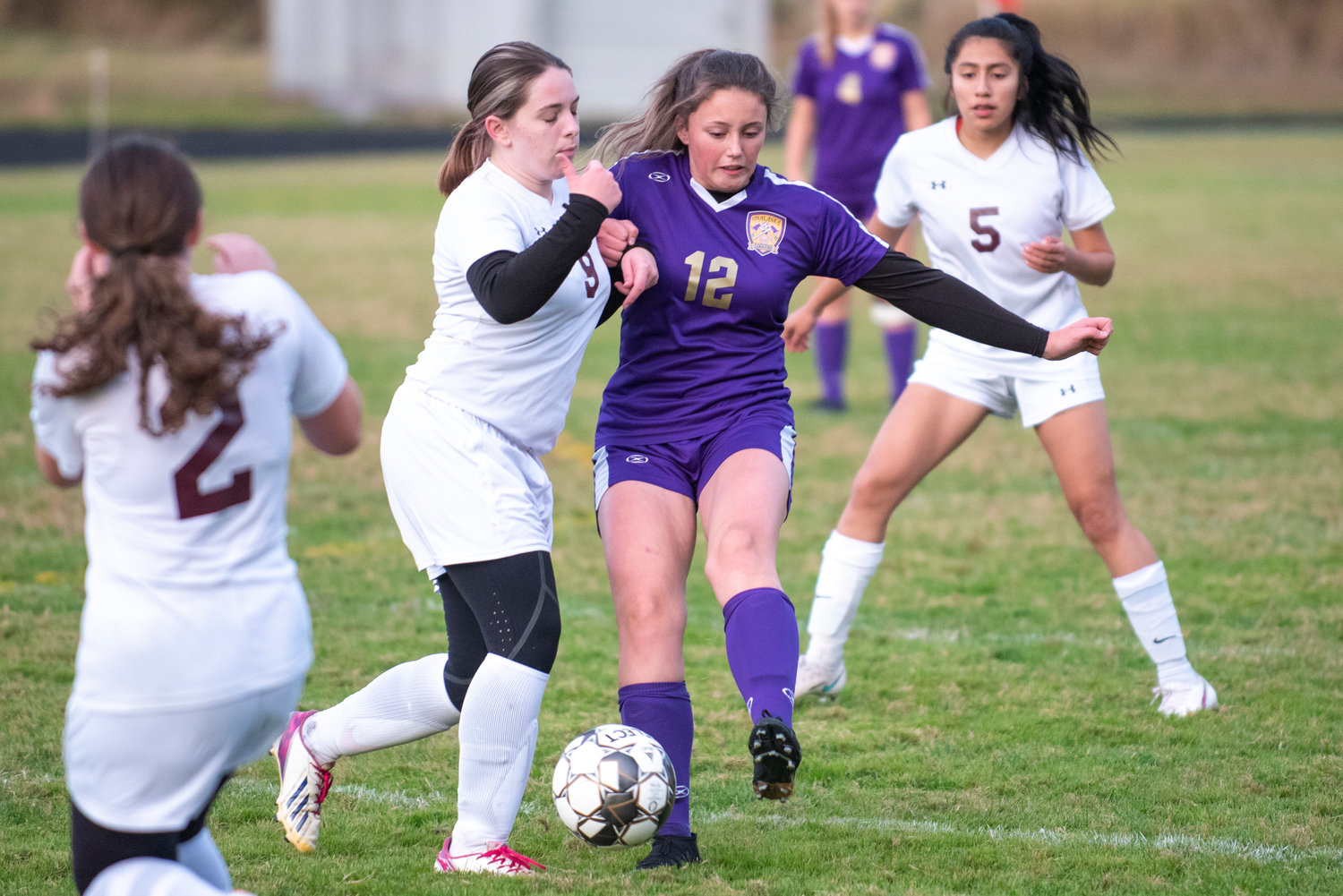 Onalaska's Jules Auman (12) gets a pass off while Winlock's Maggie Maddox (9) defends on Monday, Oct. 4, 2021...
