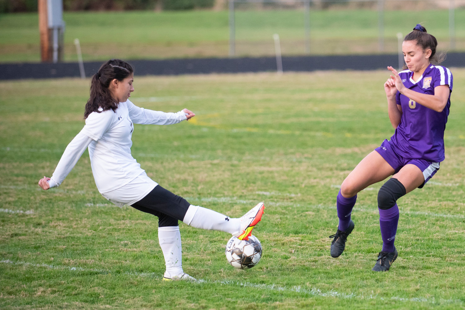 Winlock sophomore Adriana Garcia, left, boots the ball downfield in front of Onalaska's Brooklyn Sandridge (8) during a 2B Central League match on Monday, Oct. 4, 2021.