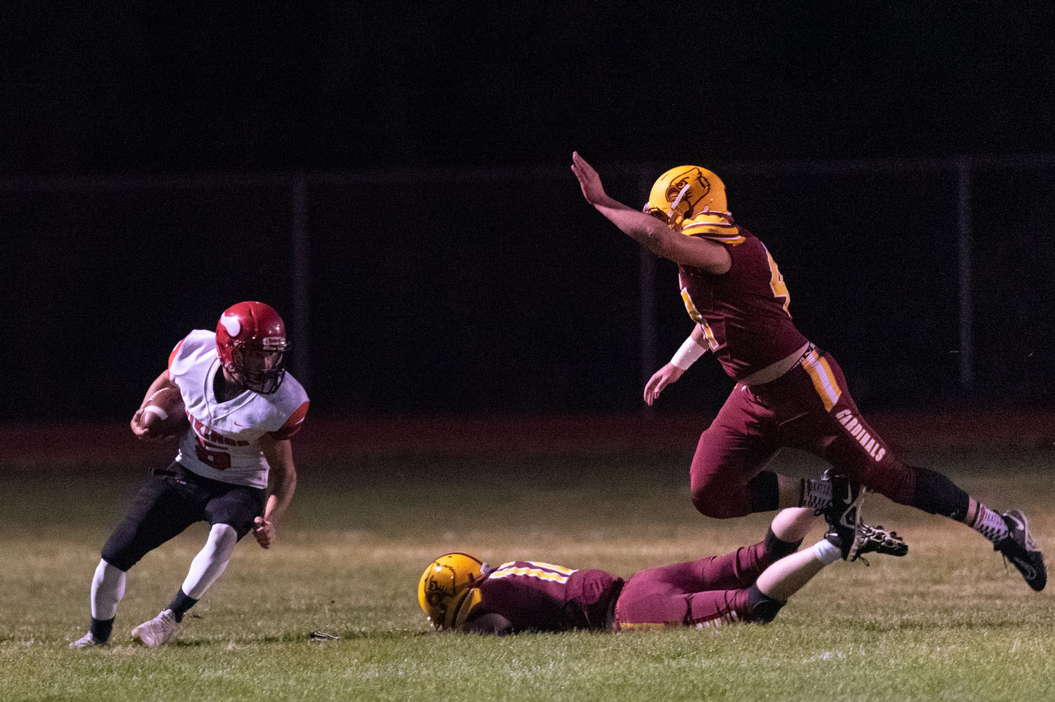 Mossyrock's Keegan Kolb (left) ducks out of the way of Winlock's Nolan Swofford (right) in the Cardinals 42-40 win Oct. 8.