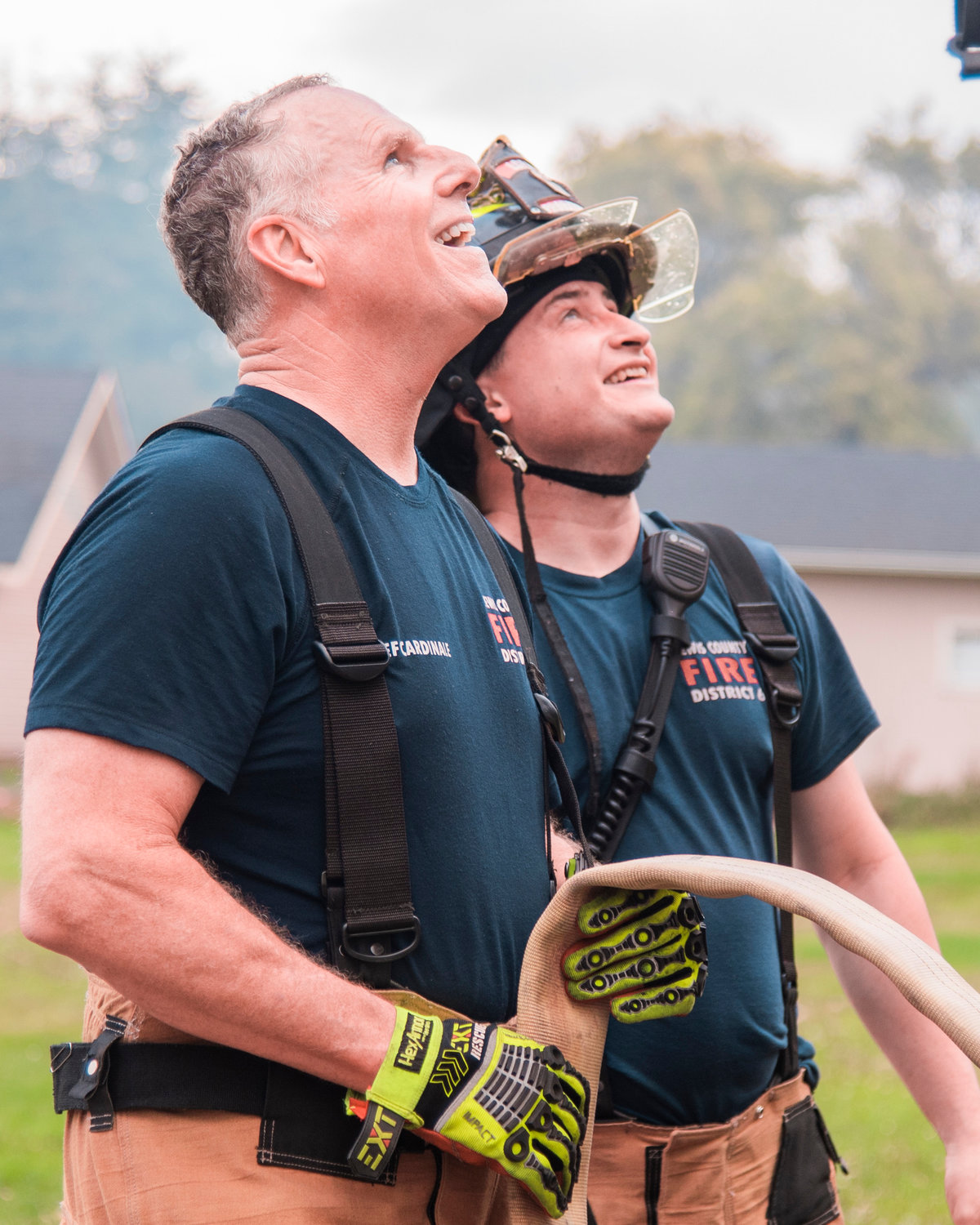 Chief Ken Cardinale, left, and Wyatt “Nutty” Hill, of Lewis County Fire District 6, smile while clearing the scene following a fire in Pe Ell Thursday afternoon.