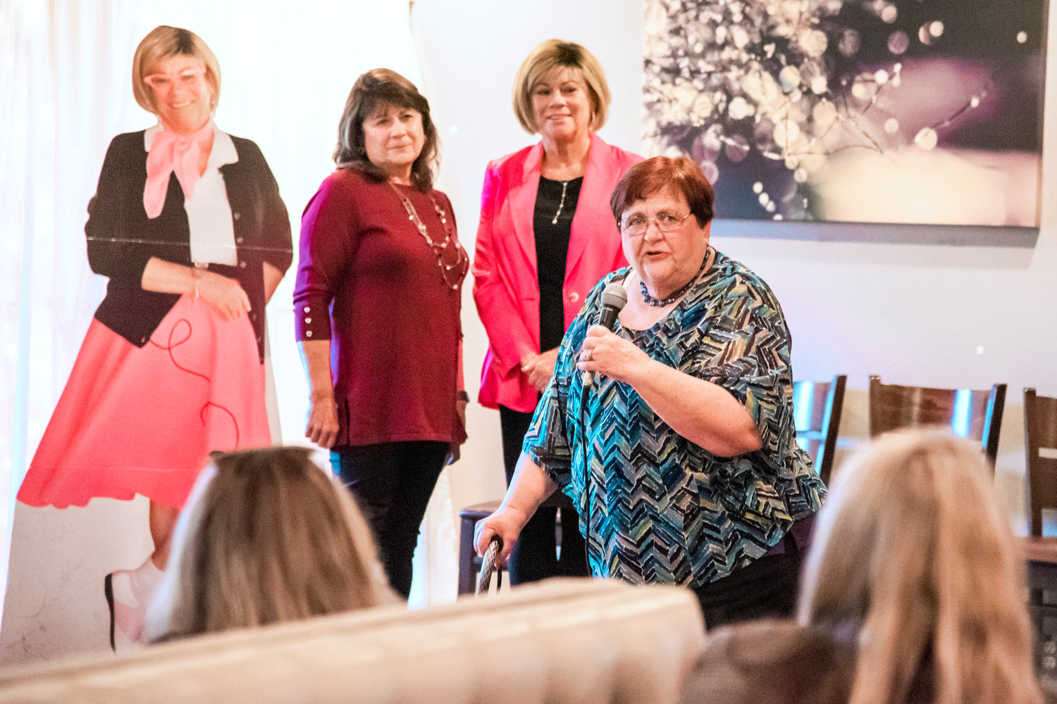 Donna Olson and Debbie Campbell look on as Doris Wood-Brumsickle talks about her time working with Campbell on the board during a retirement party held in Chehalis on Friday.