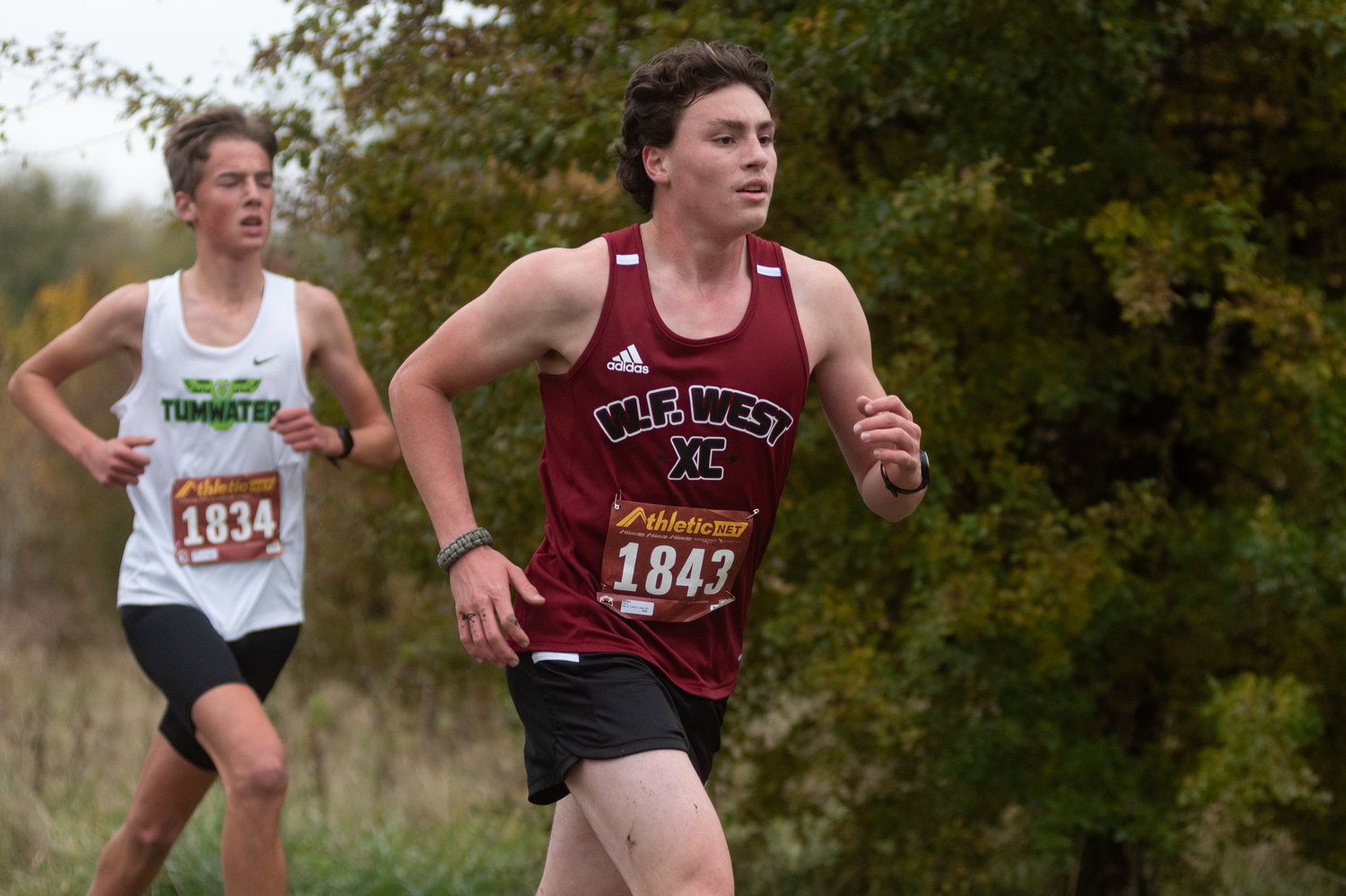 A W.F. West runner gets ahead of a Tumwater runner at the 2A Evergreen Championships at Pioneer Park Oct. 20.