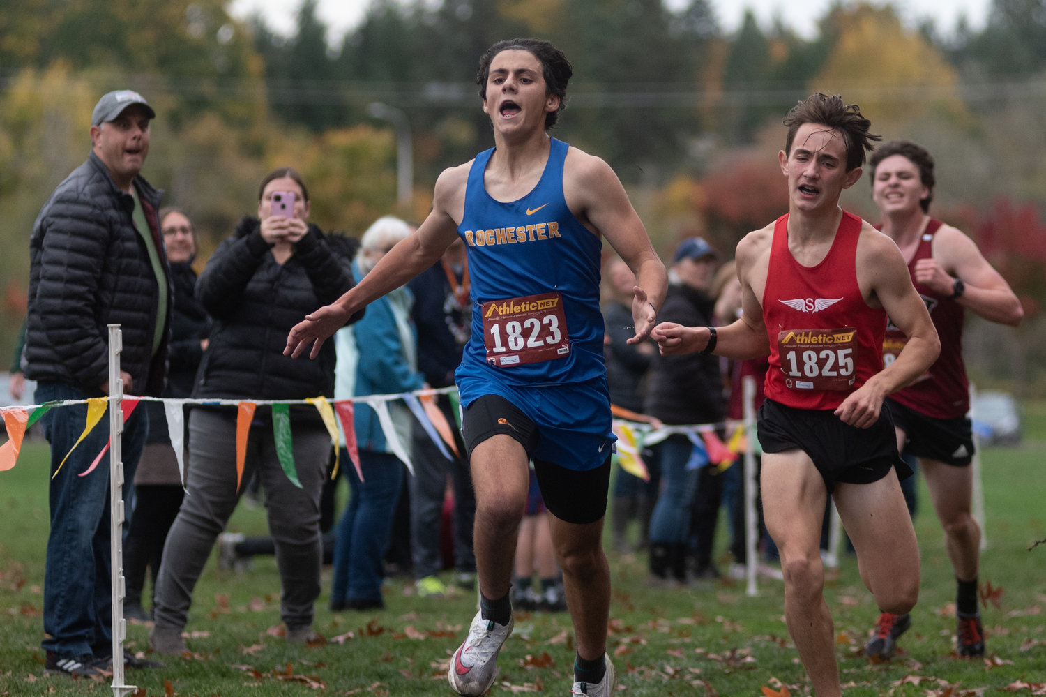 A Rochester runner lets out a yell after finishing just ahead of a Shelton runner at the 2A Evergreen Championships at Pioneer Park Oct. 20.