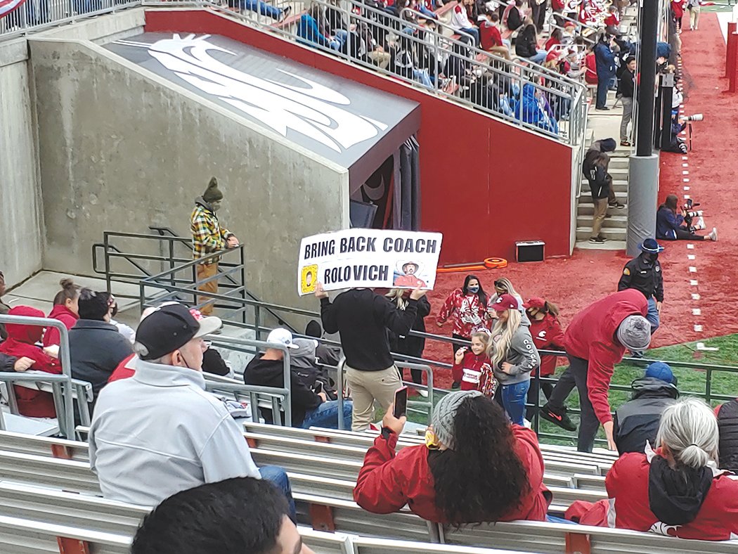 A Washington State University fan holds a sign during Saturday’s game against Brigham Young in this photograph provided by Chronicle columnist Julie McDonald. “I couldn’t disagree more with the sign,” McDonald wrote.