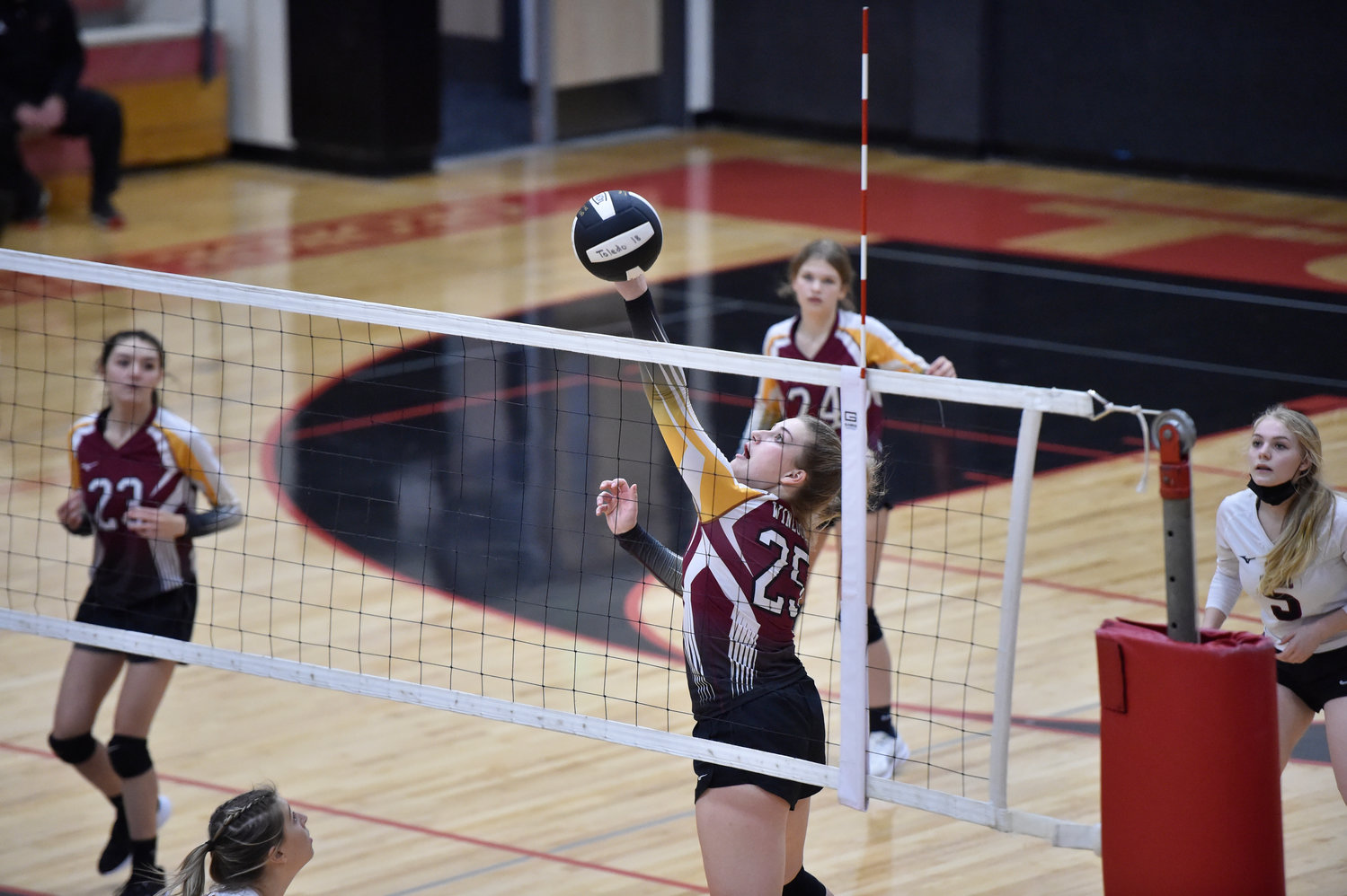 Winlock’s Addison Hall (25) tips the ball over the net in a match against Toledo on Monday, Oct. 25, in Toledo.