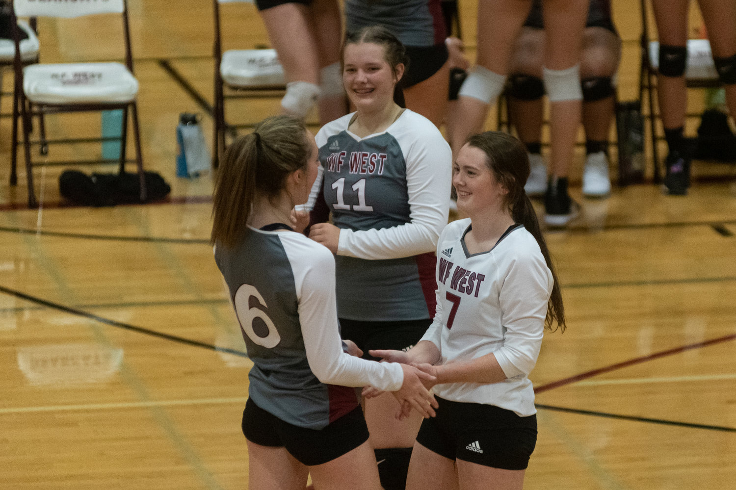 W.F. West volleyball players Kambriah Simper (7), Morgan Rogerson (6), and Savannah Hawkins (11) celebrate a point against Aberdeen Oct. 26.