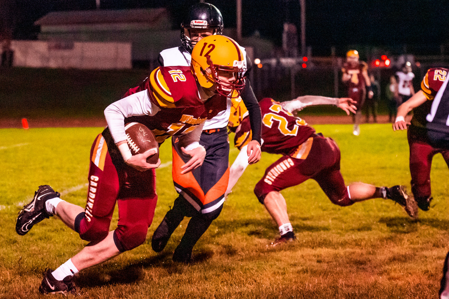 Winlock’s Chase Scofield (12) scoops a fumble forced by Senior Neal Patching (23) Friday night.