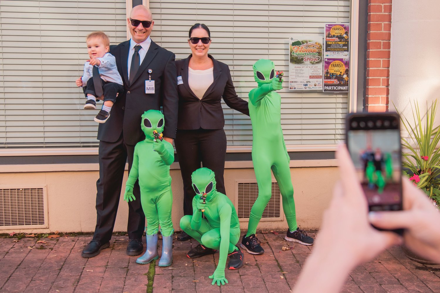 FILE PHOTO — State Rep. Peter Abbarno smiles and poses for a photo with aliens and other "MIB" agents in downtown Centralia in 2021.