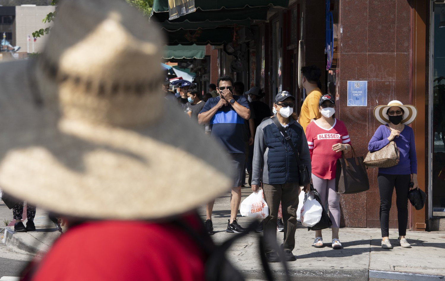 California's strict mask mandate has helped prevent the spread of COVID-19. But now, as the weather gets cooler and people go inside more, the disease could spread. Here, visitors to Chinatown wear masks in July 2021 in Los Angeles (Myung J. Chun/Los Angeles Times/TNS)