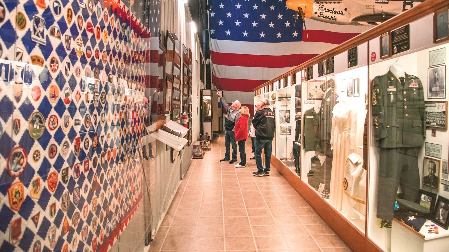 Visitors at the Veterans Memorial Museum point to photos and displays on Veterans Day in Chehalis in 2021.
