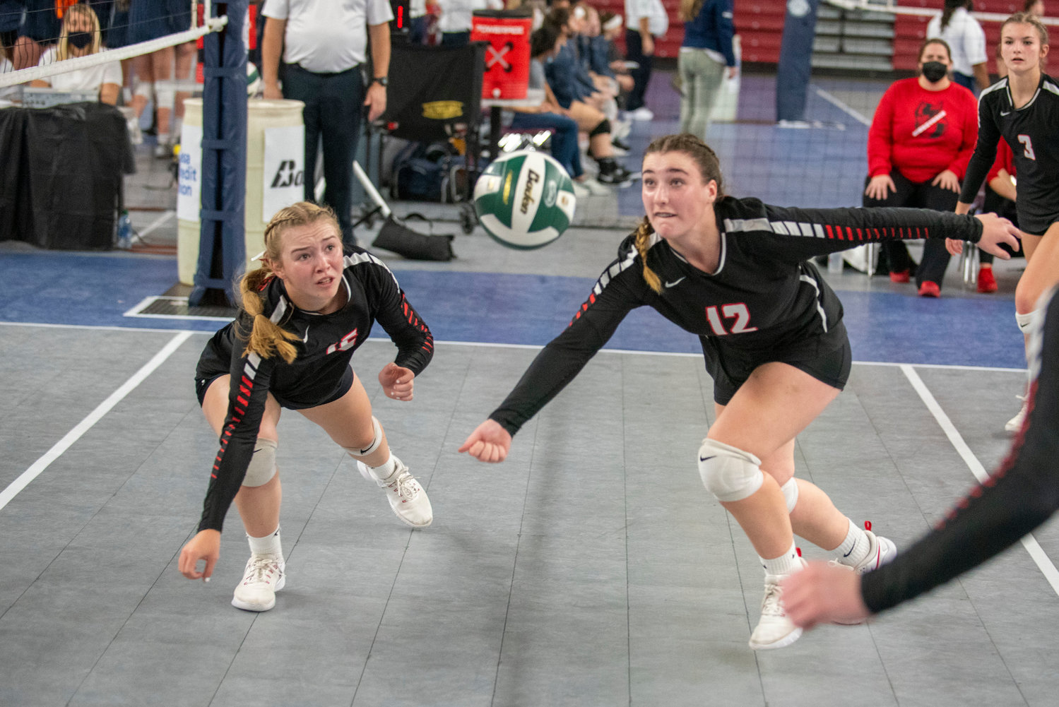 Mossyrock’s Hailey Brooks, left, and Caelyn Marshall (12) dive for a loose ball against Oakesdale during the 1B state championship match Friday in Yakima.